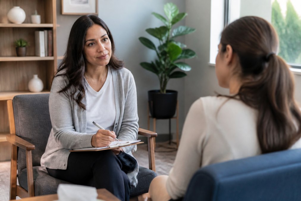 Compassionate psychiatrist listening attentively to patient during consultation in calm, welcoming office with soft natural lighting and comfortable seating